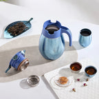 Blue titanium thermal carafe flatlay with its lid, press-lock module and filter basket disassembled