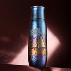 Monet Sailboat pure titanium infuser tumbler in iridescent blue on draped pink fabric under dramatic light
