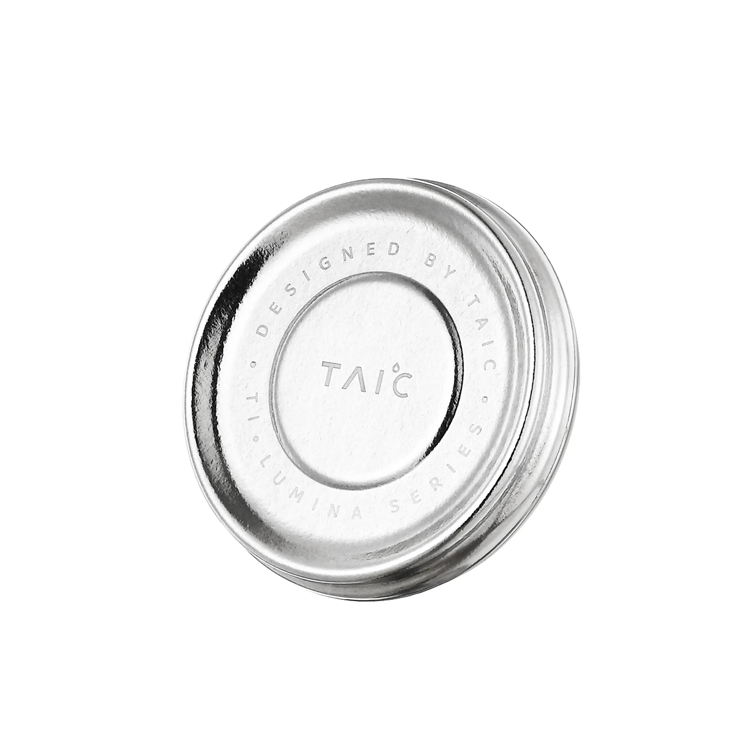 Close-up of titanium mug lid engraved 'Designed by TAIC Ti Lumina Series', top view