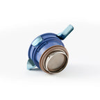 Detail of the blue press-to-lock lid module and sealing gasket from the titanium thermal carafe