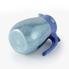 Blue titanium thermal carafe resting on its side, revealing the base with a pure titanium 'Ti' stamp