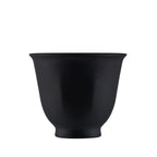 Single matte black pure titanium tea cup with flared double-wall rim, front view on white background