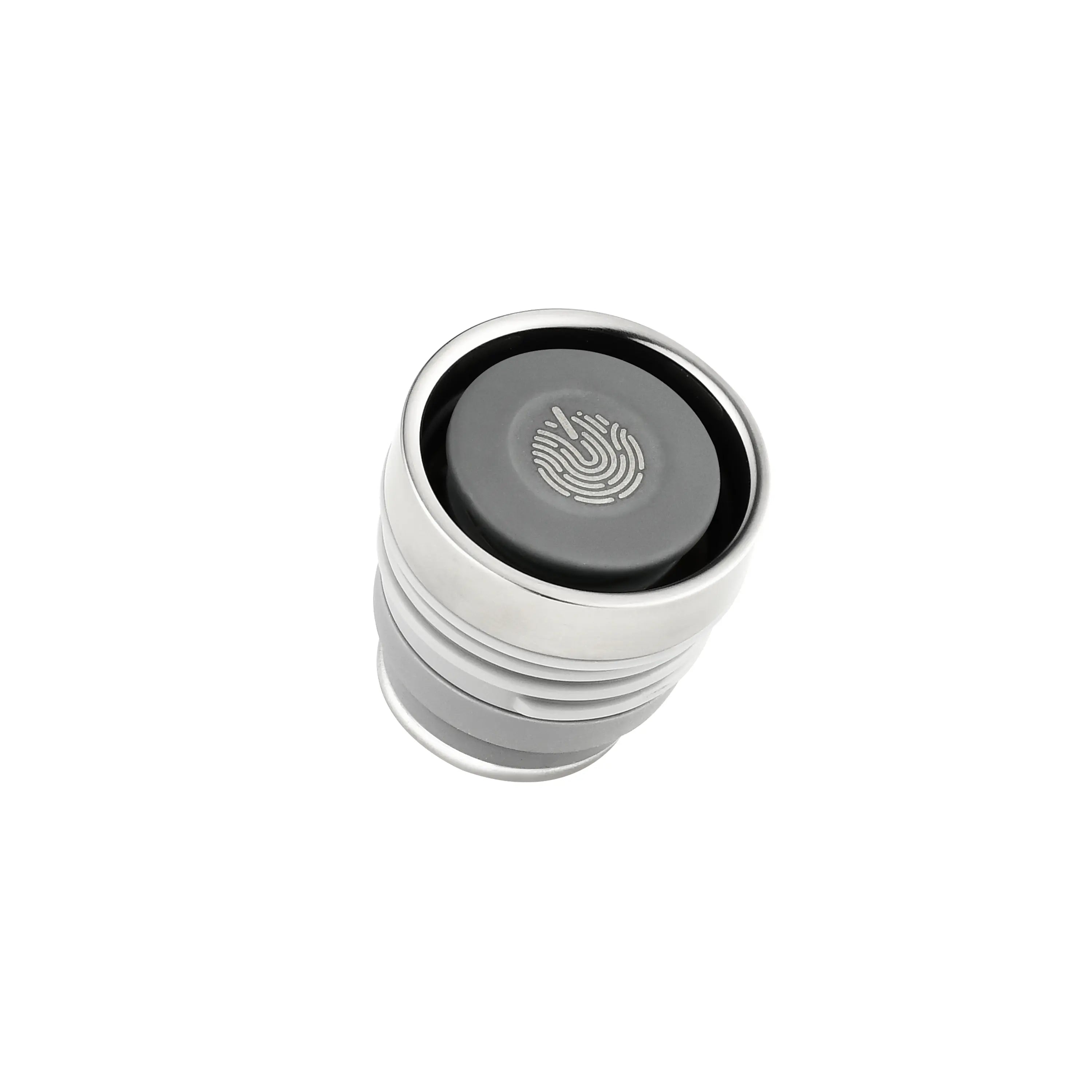 Monet Sailboat titanium infuser tumbler lid, top-down close-up of press button with etched wave emblem