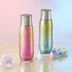 Pink and green Aurora pure titanium tea infuser tumblers on rippling water with fresh spring flowers
