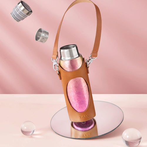 Aurora titanium tea infuser tumbler in tan leather carrier sleeve with strap, pink finish, cap parts floating above
