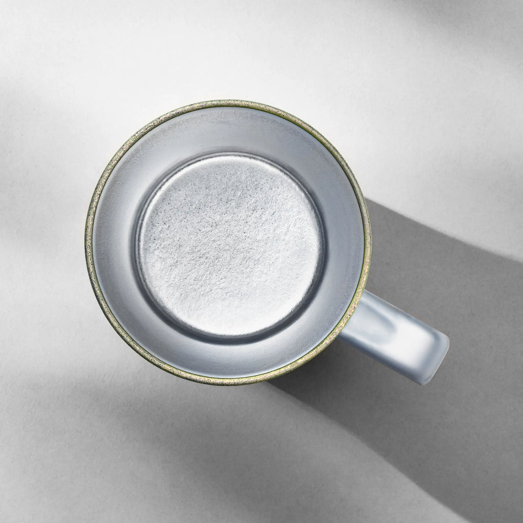 Top-down view into an empty titanium mug showing its seamless wide-mouth interior liner