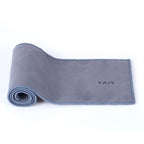 Pure titanium travel tea set accessory, grey microfiber tea towel partly rolled on white background